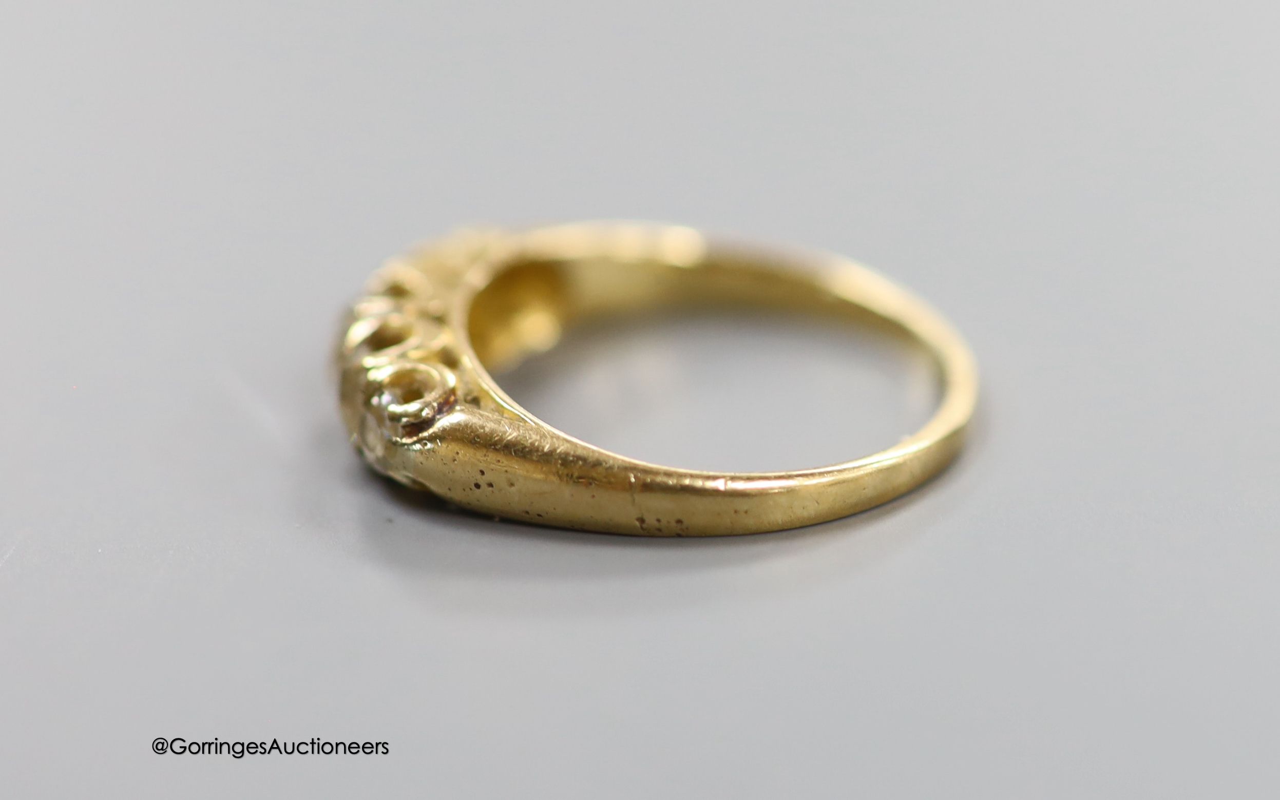 An 18ct and graduated five stone diamond set half hoop ring, size L, gross 2.6 grams.